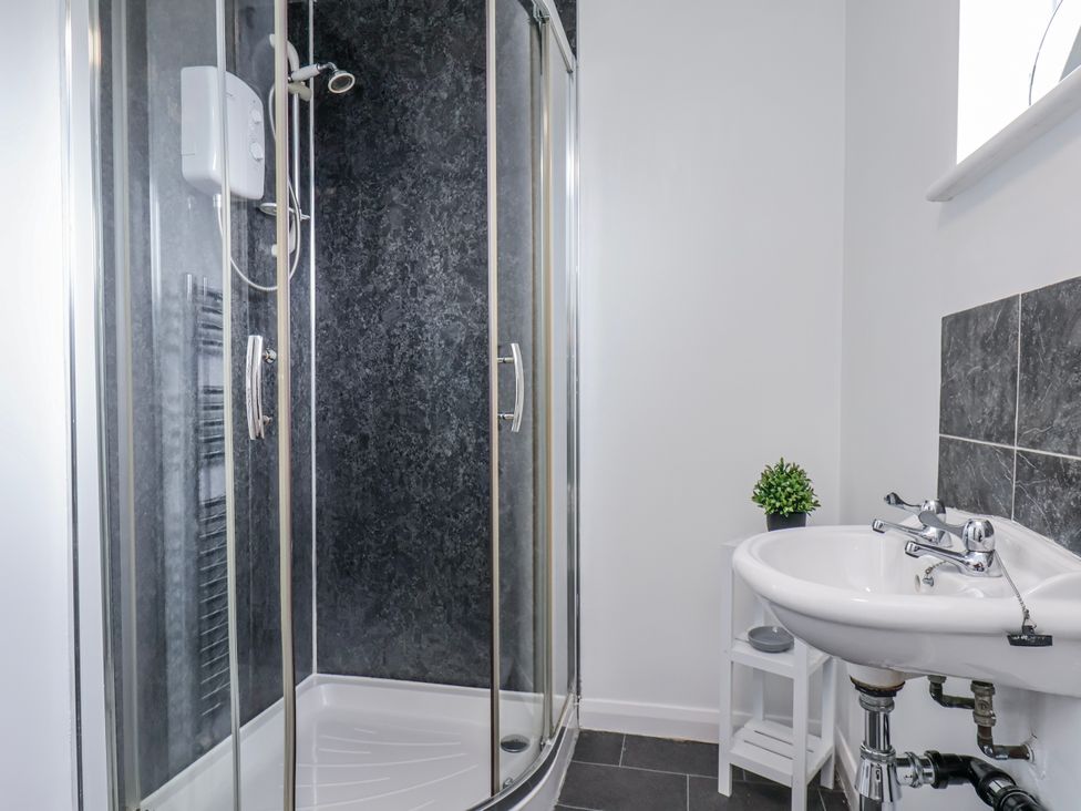 A bathroom with a shower and sink at 34 Fountain Close Whitby
