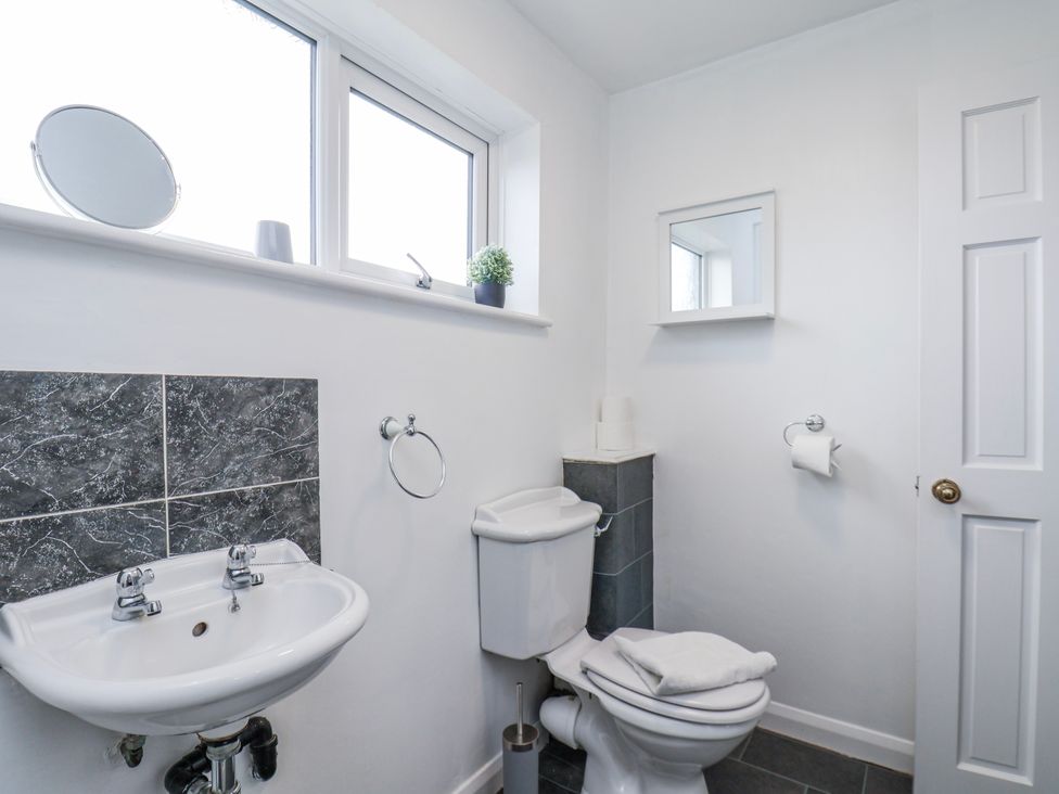 A bathroom with a sink and toilet at 34 Fountain Close in Whitby