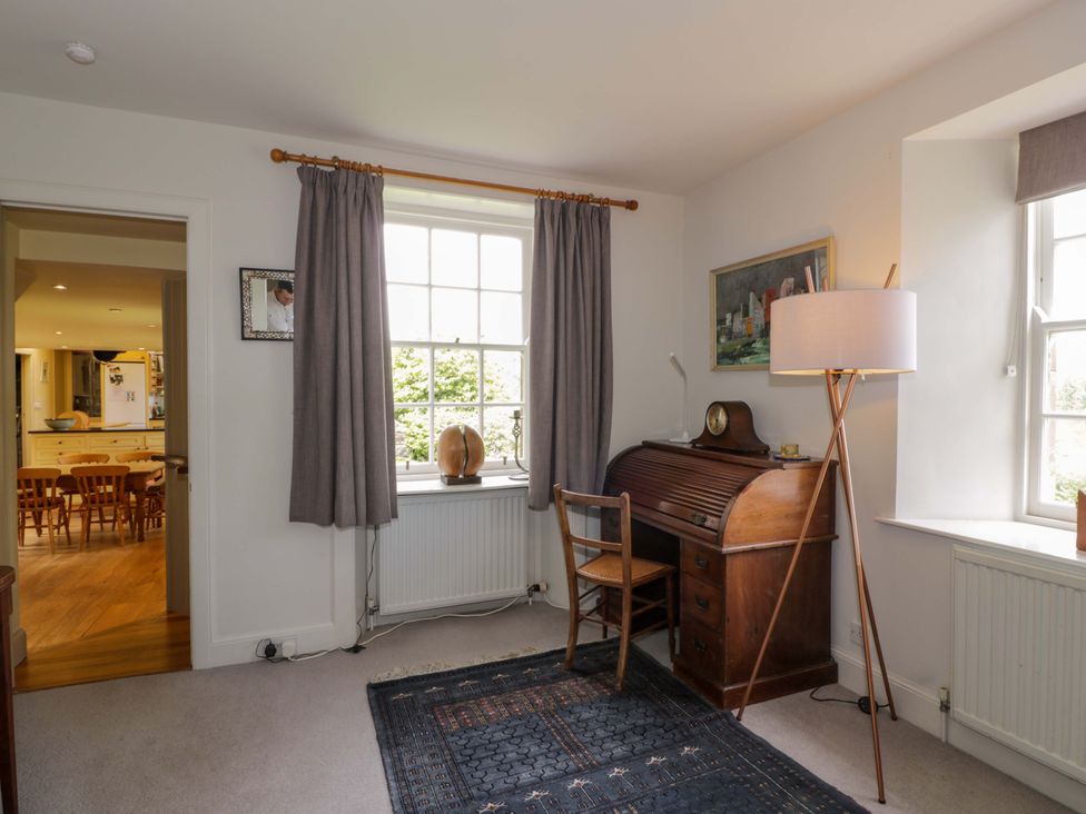 An office with a desk, chair, and lamp at Townhead of Auchenbainzie near Thornhill