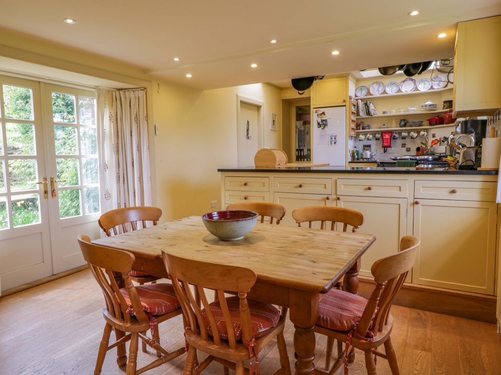 A kitchen with a dining table and chairs at Townhead of Auchenbainzie near Thornhill