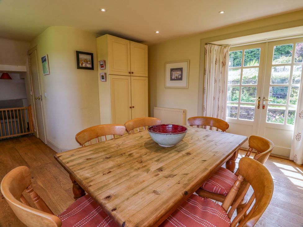 A dining room with a wooden table and chairs at Townhead of Auchenbainzie near Thornhill