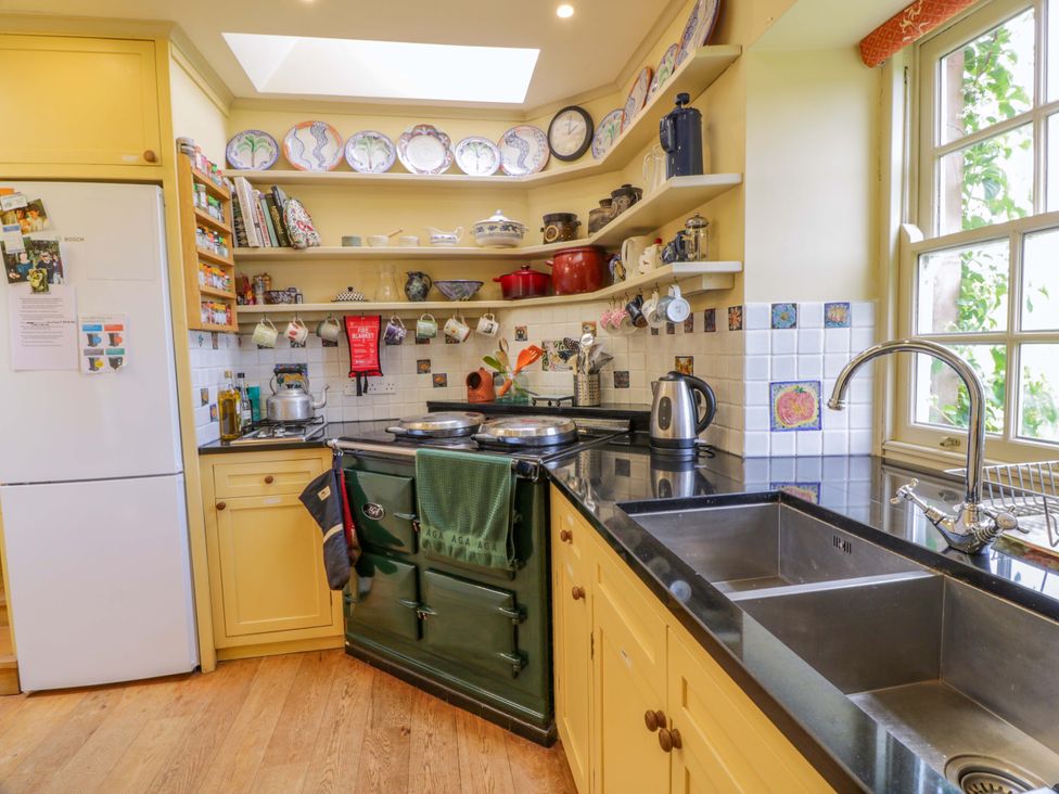 A kitchen with a stove and refrigerator at Townhead of Auchenbainzie near Thornhill