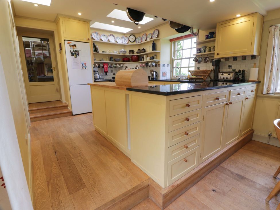 A kitchen with a central island and various appliances at Townhead of Auchenbainzie near Thornhill