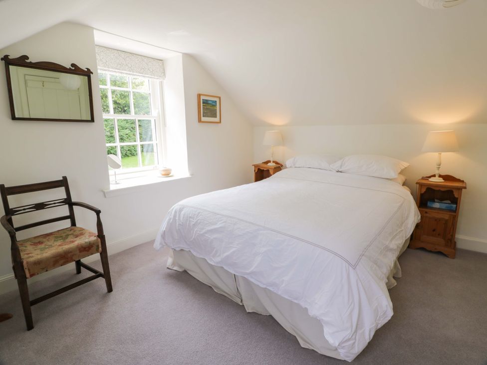 A bedroom with a bed and nightstands at Townhead of Auchenbainzie near Thornhill