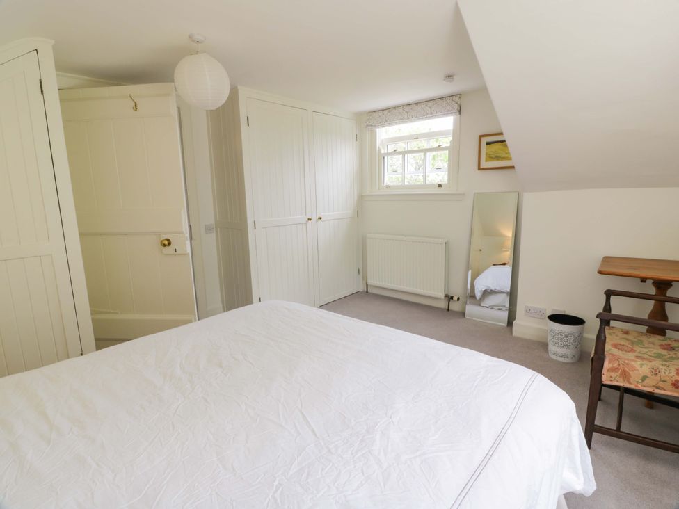 A bedroom with a bed and wardrobe at Townhead of Auchenbainzie near Thornhill