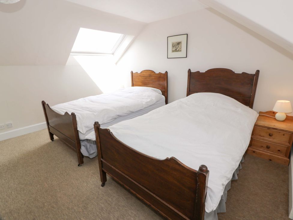 A bedroom with two beds and a lamp at Townhead of Auchenbainzie near Thornhill