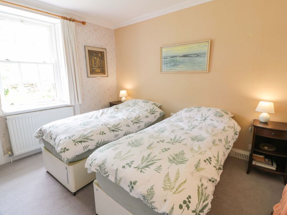 A bedroom with two beds and a window at Townhead of Auchenbainzie near Thornhill
