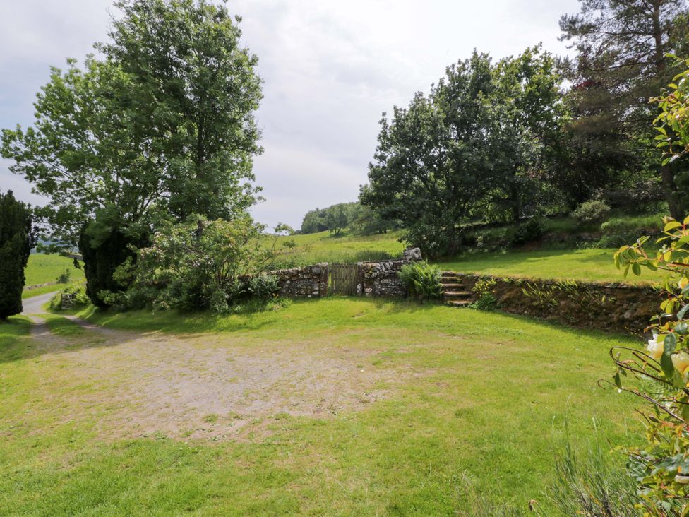 A garden with trees and a stone wall at Townhead of Auchenbainzie near Thornhill