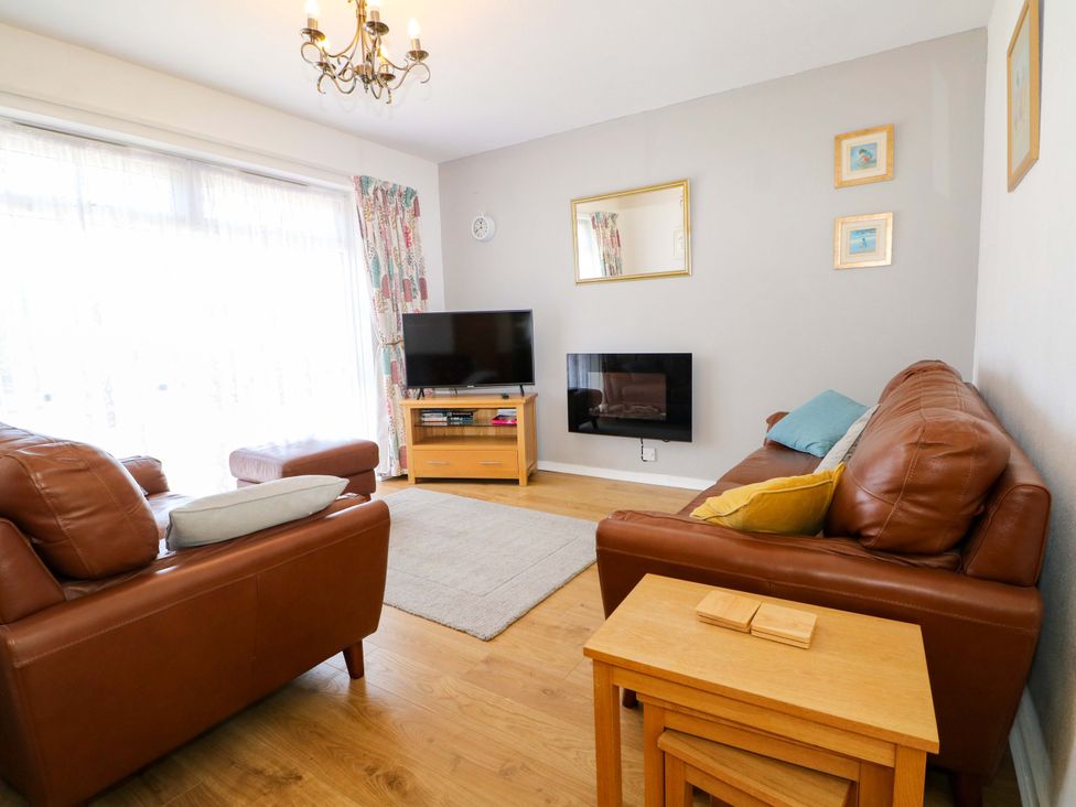 A living room with sofa and television at Dymchurch Bungalow in Romney Marsh