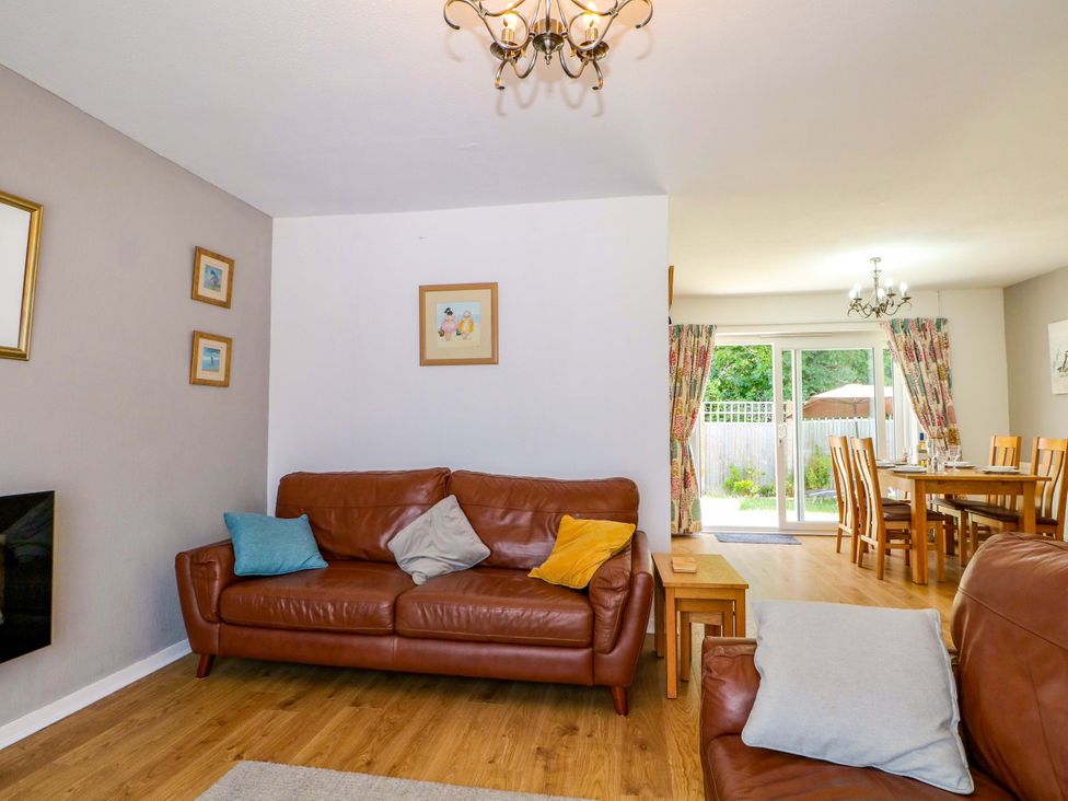 A living room with a sofa and dining table at Dymchurch Bungalow Romney Marsh