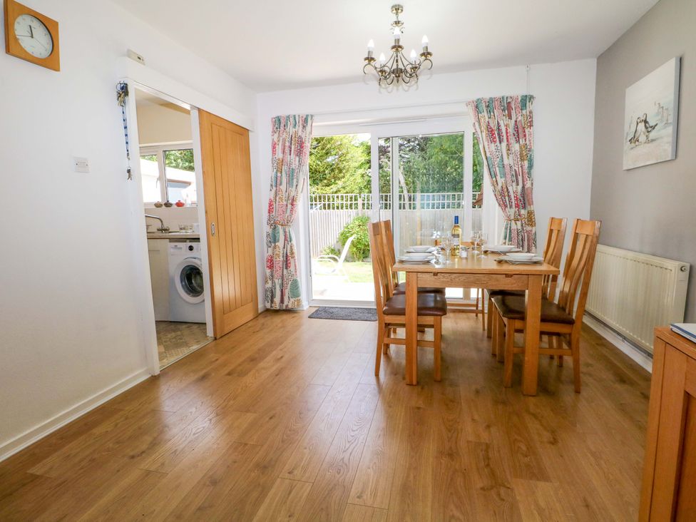 A dining room with a table and chairs at Dymchurch Bungalow in Romney Marsh