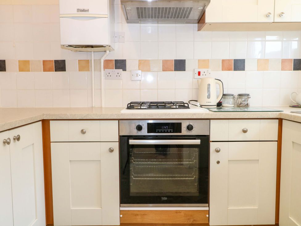 A kitchen with an oven and stove at Dymchurch Bungalow in Romney Marsh