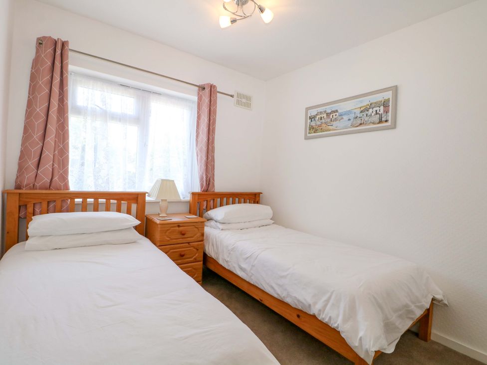 A bedroom with two single beds and a nightstand at Dymchurch Bungalow in Romney Marsh