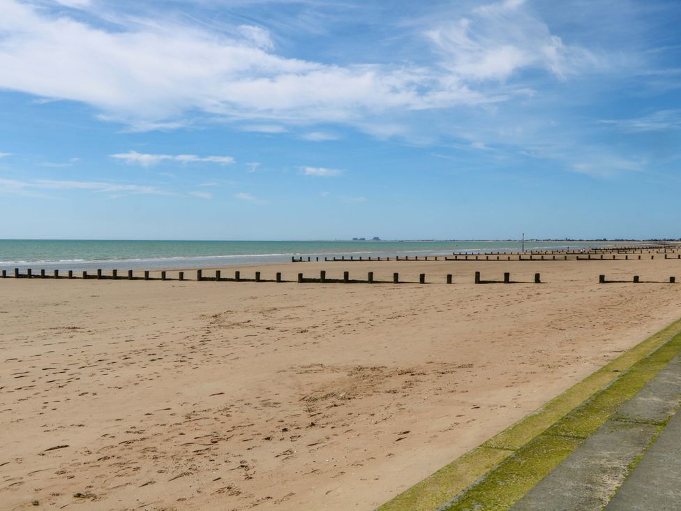 A beach with sand and groynes at Dymchurch Bungalow in Romney Marsh
