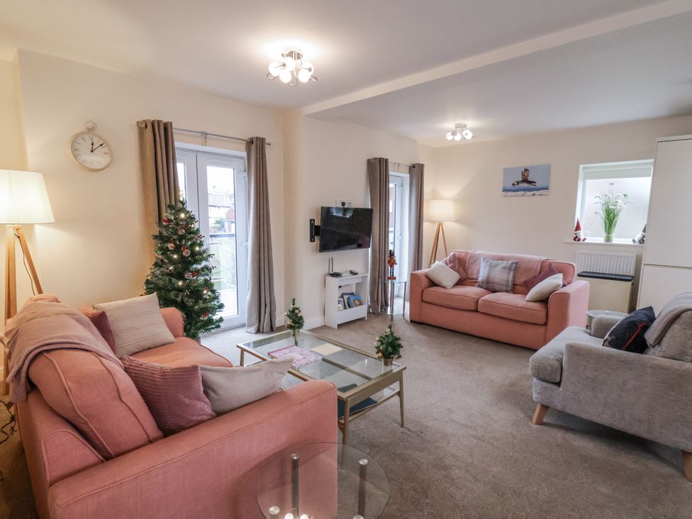 A living room with sofas and a television at Weydale Avenue in Scarborough