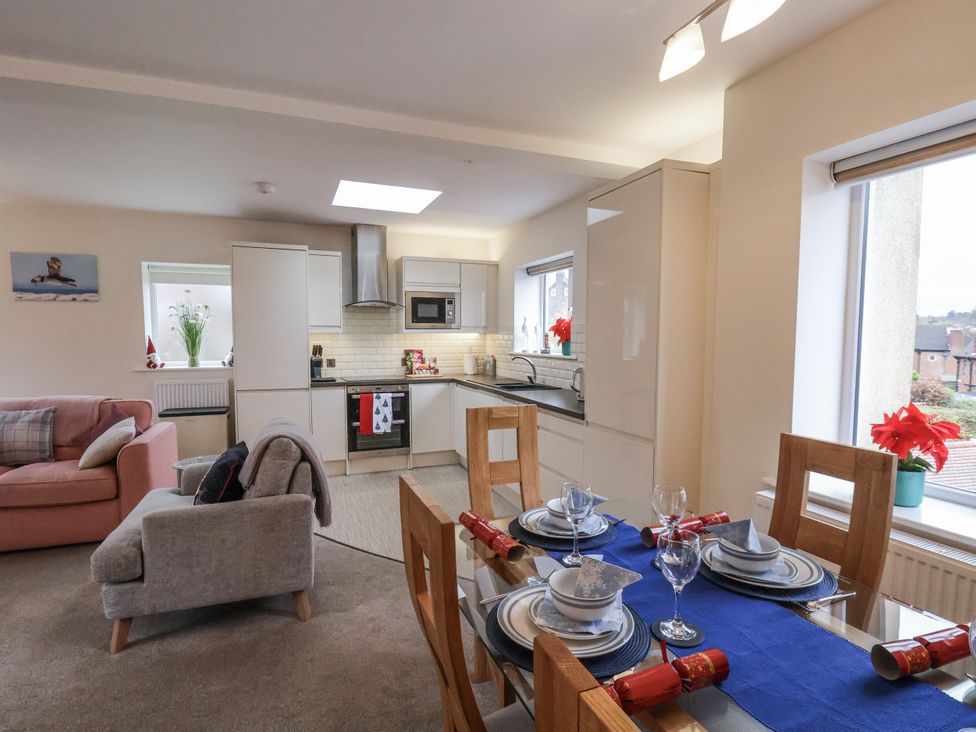A kitchen and dining area with a table set for dinner at Weydale Avenue in Scarborough