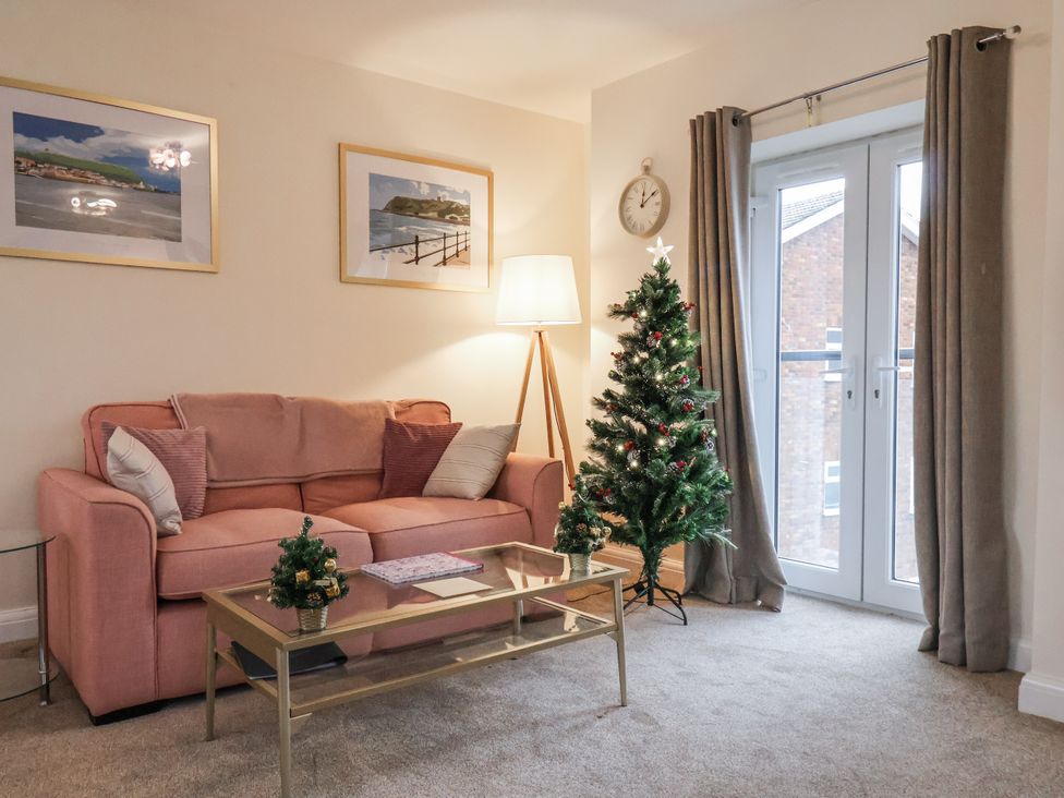 A living room with a sofa and Christmas tree at Weydale Avenue in Scarborough