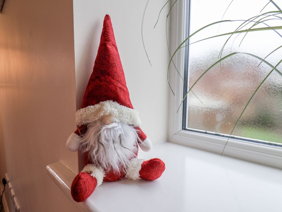 A decorative figure sitting on a windowsill at Weydale Avenue in Scarborough