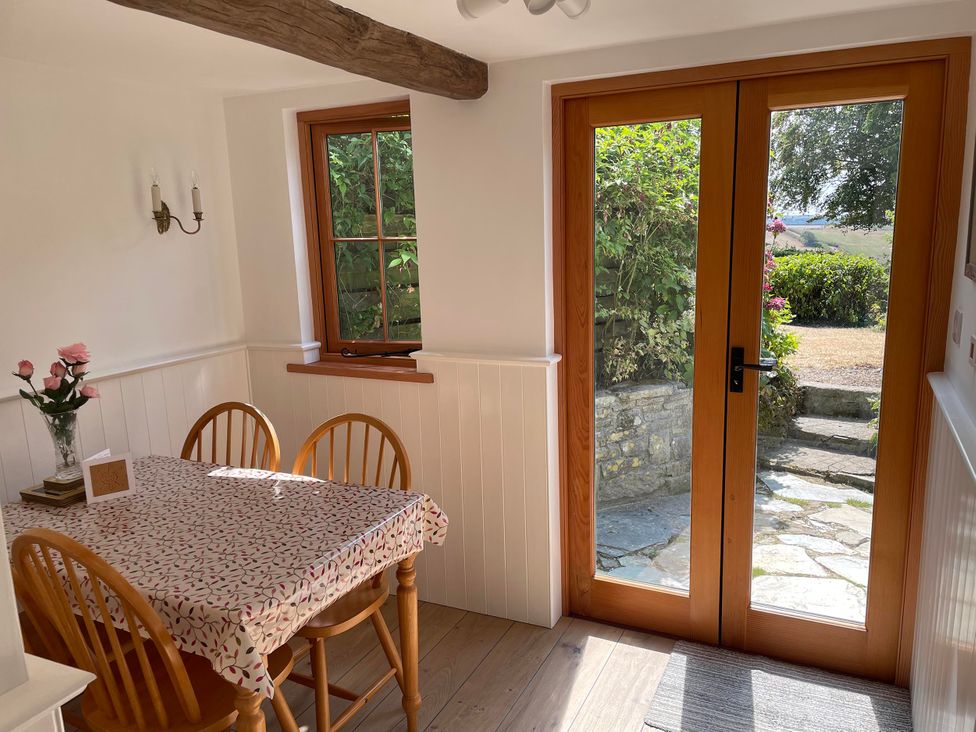 A dining room with a table and chairs at Bell Buoy Cottage in Morwenstow