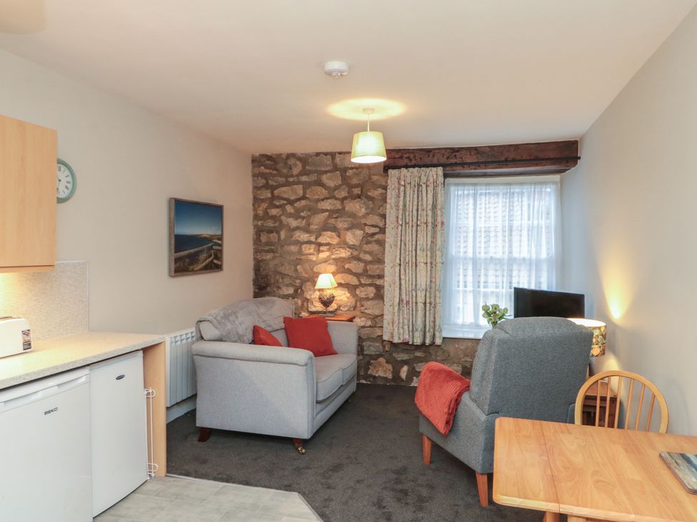 A living room with a sofa and armchair at Beck View