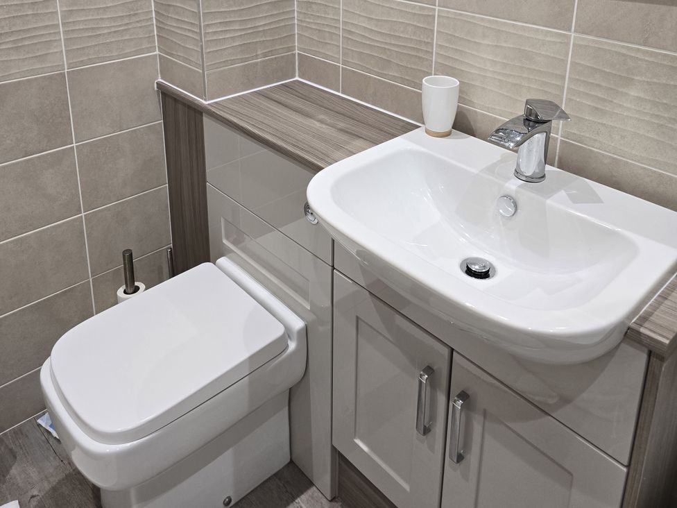 A bathroom featuring a toilet and sink at Puffin Cottage The Bay - Filey