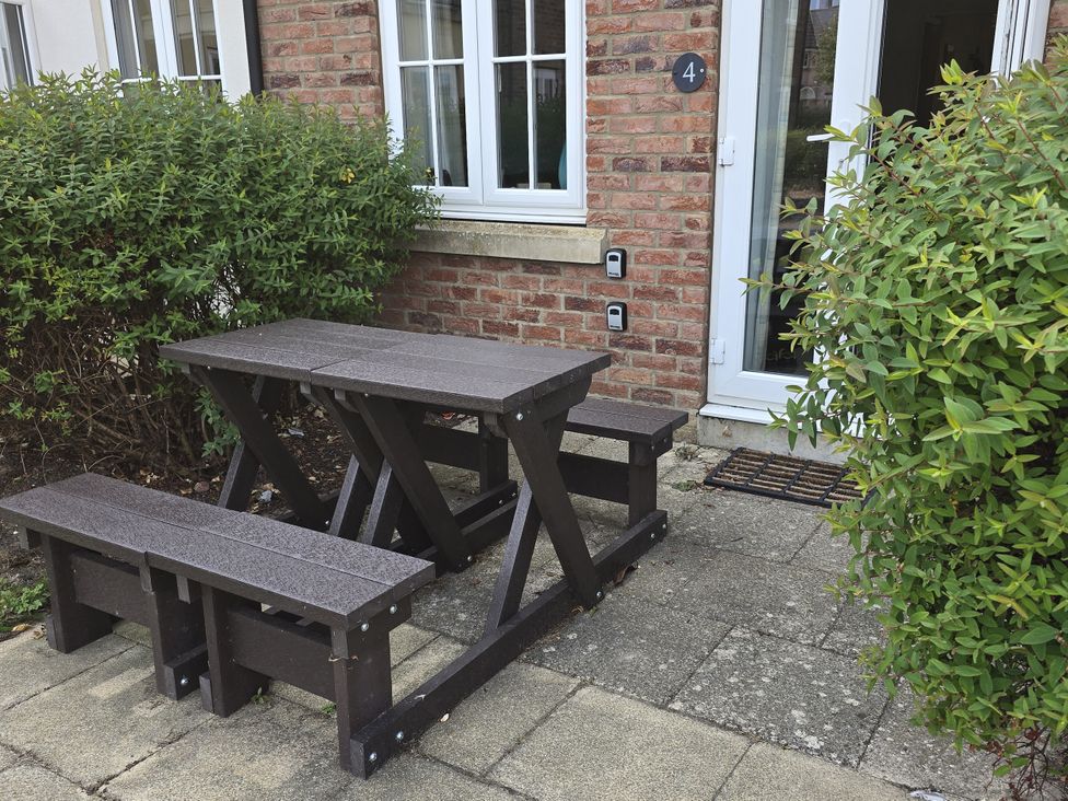 A seating area with a table and benches outside at Puffin Cottage The Bay - Filey