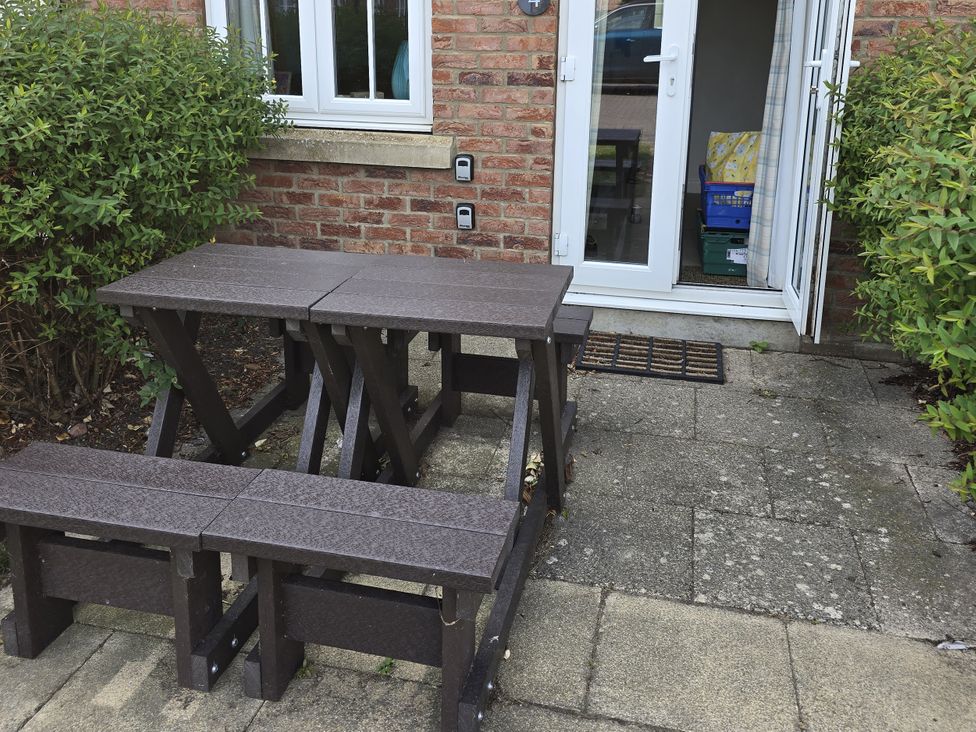 A table and benches in an outdoor area at Puffin Cottage The Bay - Filey