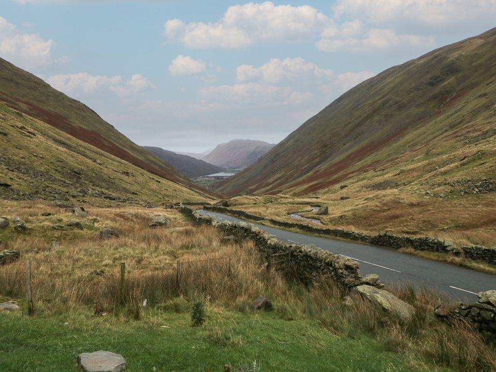 A valley with a road and hills at Hideaway Cottage Penrith