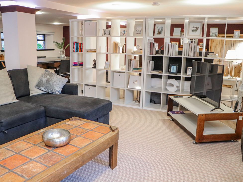 A living room with a sofa and coffee table at Mary Ann Apartment in Inverness