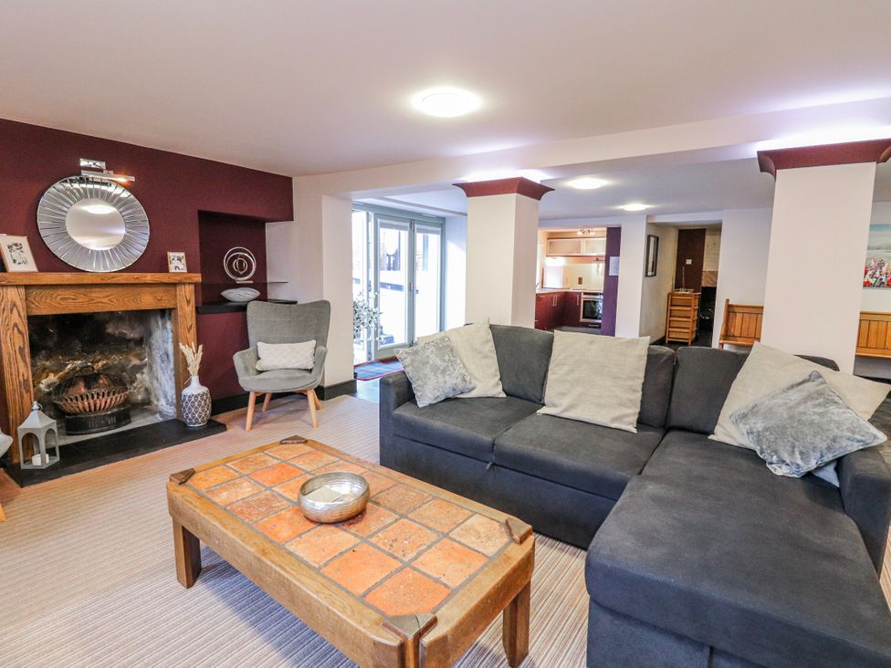 A living room with a sofa and fireplace at Mary Ann Apartment in Inverness