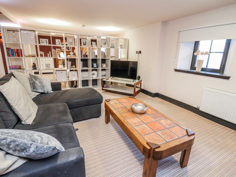 A living room with a sofa and coffee table at Mary Ann Apartment in Inverness