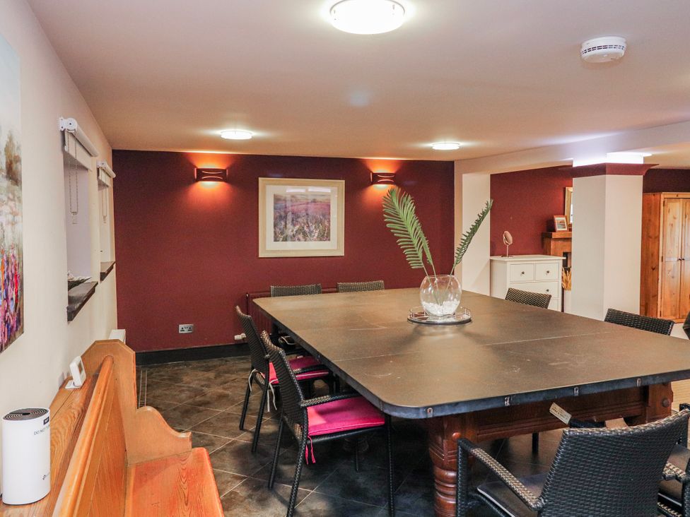 A dining room with a large table and chairs at Mary Ann Apartment in Inverness