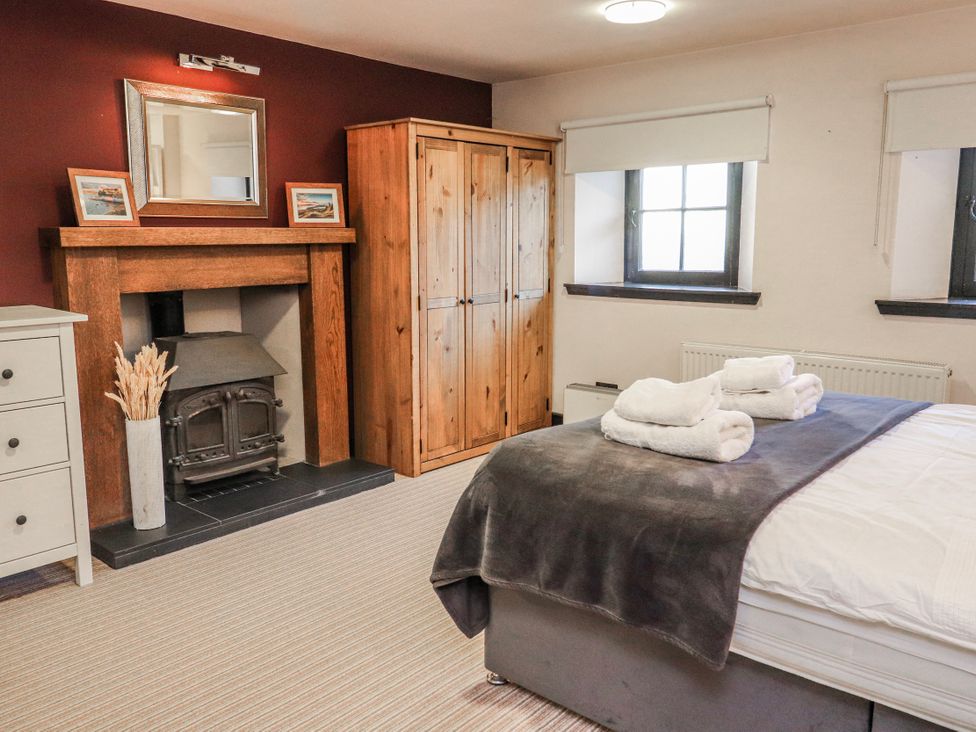 A bedroom with a bed and a wardrobe at Mary Ann Apartment in Inverness