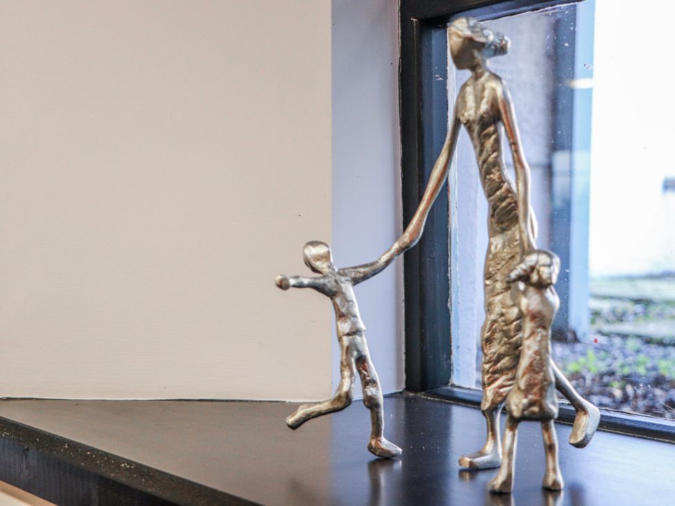 A statue of a woman holding a child's hand at Mary Ann Apartment Inverness