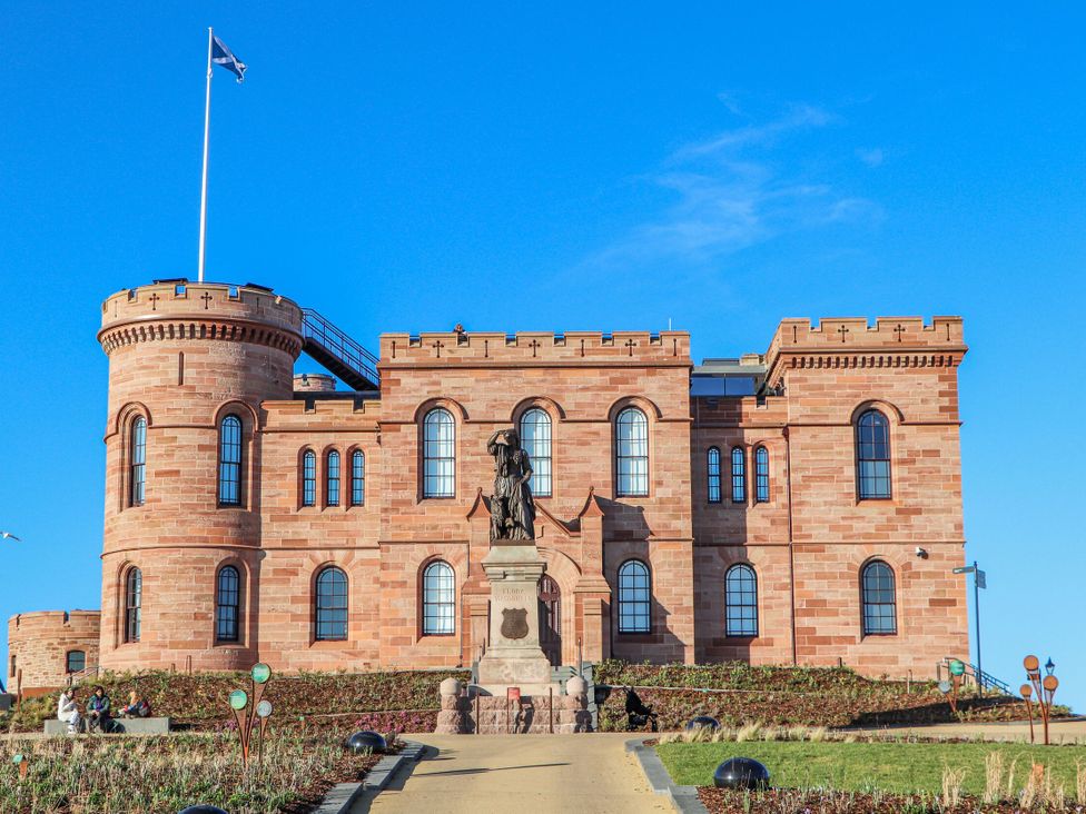 A building with a statue in front at Mary Ann Apartment in Inverness