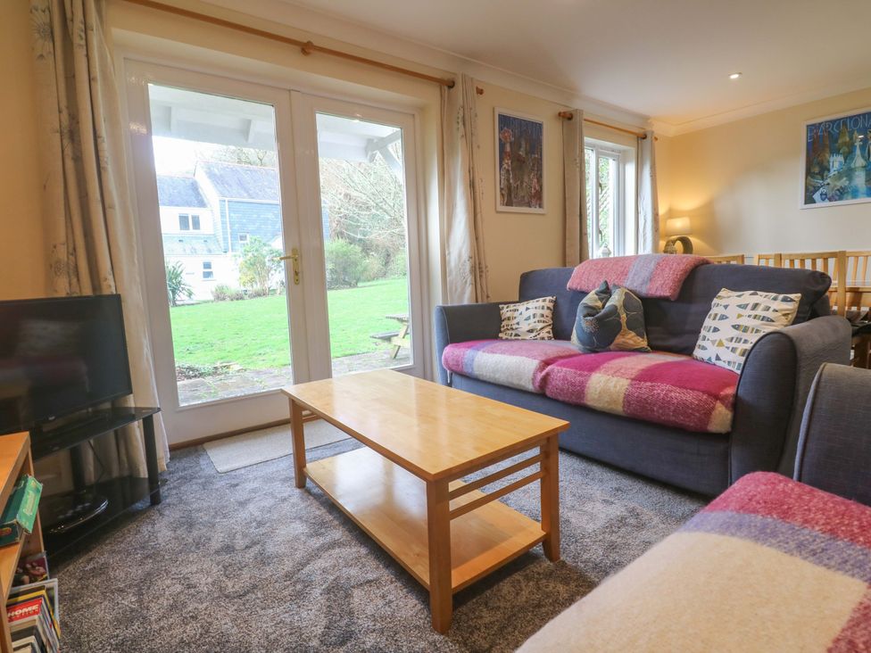 A living room with sofa and coffee table at Pheasants Walk in Falmouth