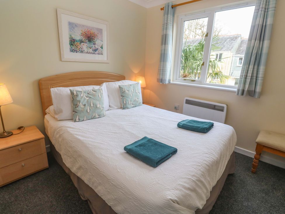 A bedroom with a double bed and pillows at Pheasants Walk in Falmouth