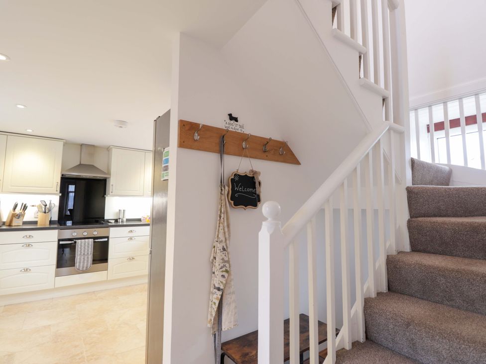 A kitchen with stairs and hooks for hanging at Nanville in Muir of Ord and Beauly