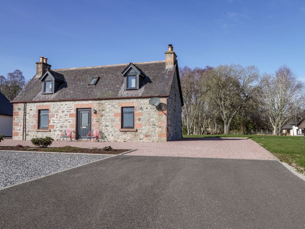 A house with a satellite dish and driveway at Nanville in Muir of Ord and Beauly