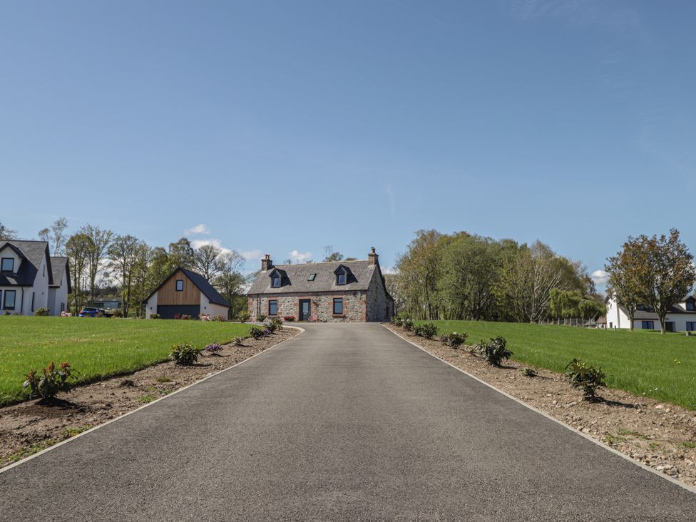 A house with a driveway and garden at Nanville in Muir of Ord and Beauly