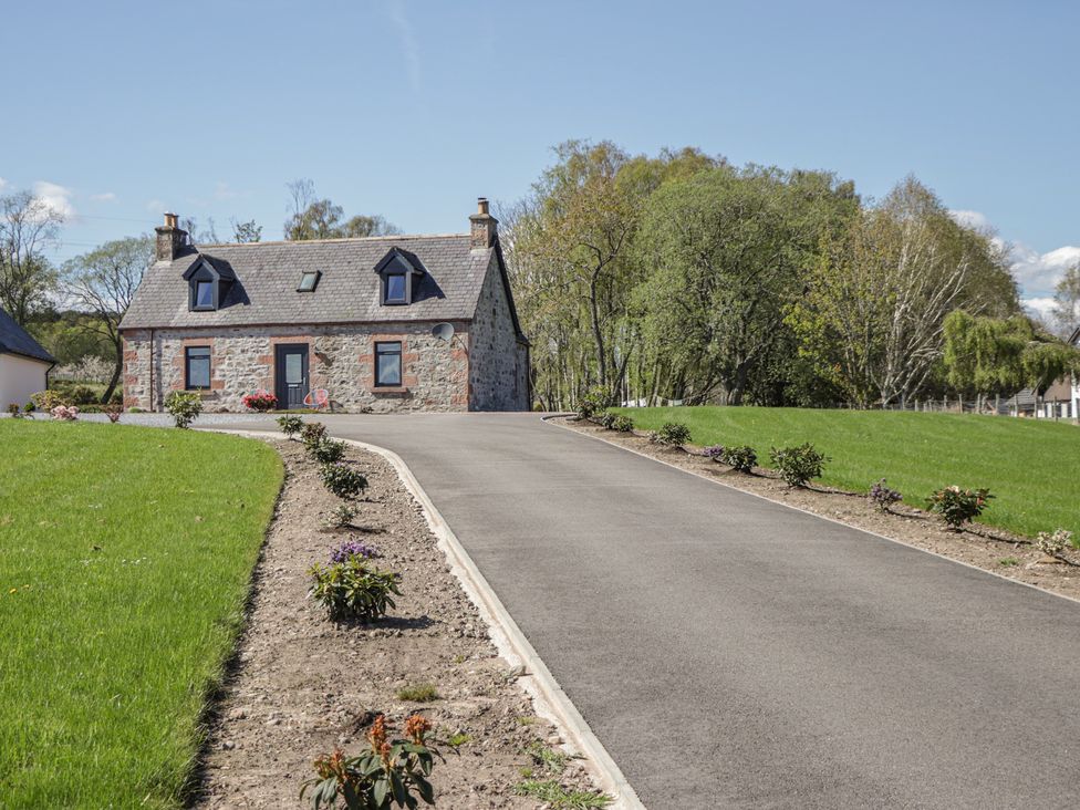 A house with a driveway and garden at Nanville in Muir of Ord and Beauly