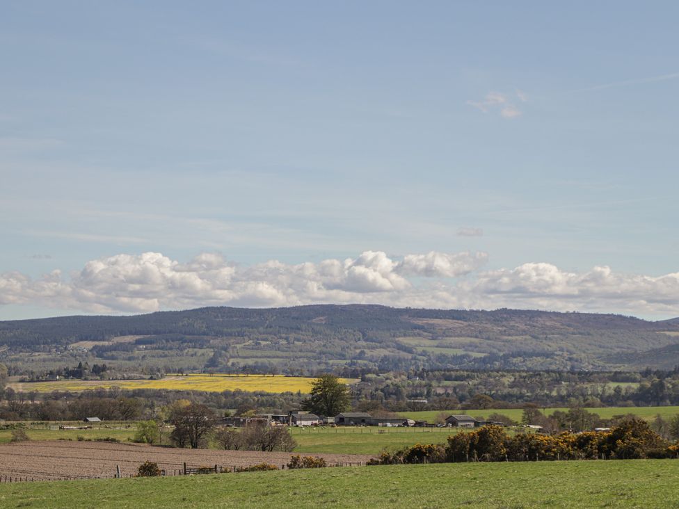 A landscape with fields and mountains at Nanville in Muir of Ord and Beauly