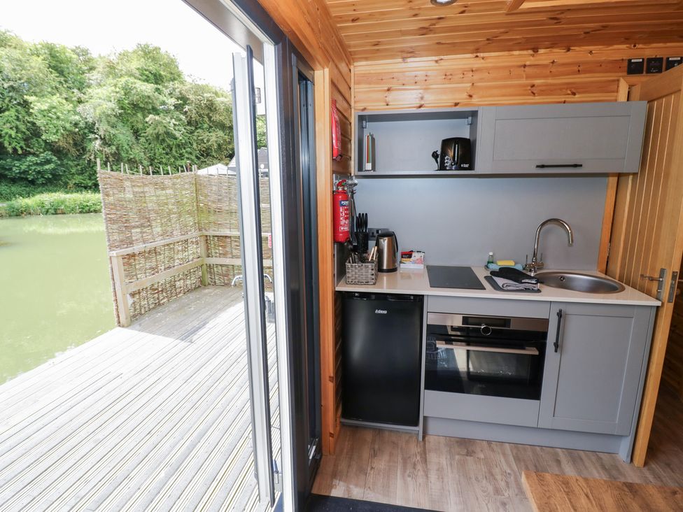 A kitchen with appliances at Oak Lodge At Bridge Lake Farm & Fishery Chacombe