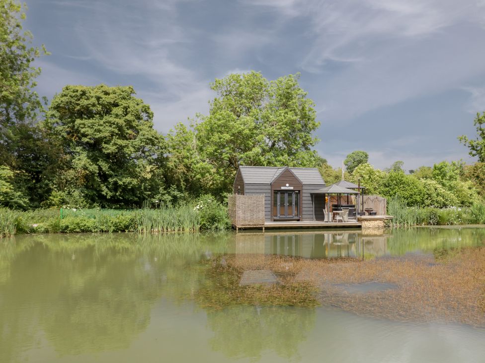 A cabin by a pond at Oak Lodge At Bridge Lake Farm & Fishery Chacombe