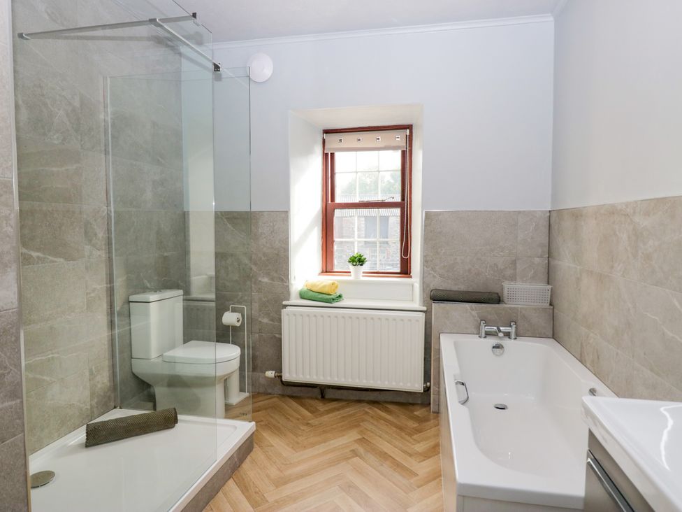 A bathroom with a shower and bathtub at Beckside Farm Bootle near Millom, Cumbria