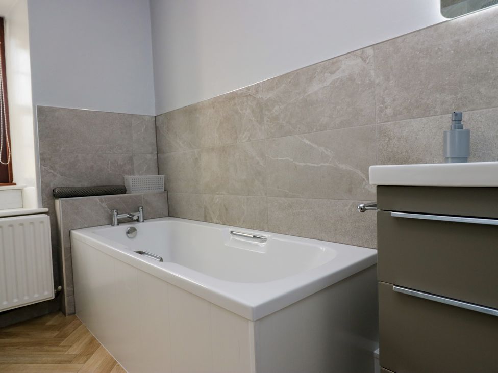 A bathroom with a bathtub and sink at Beckside Farm Bootle near Millom Cumbria