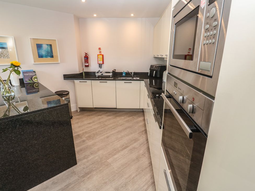 A kitchen with appliances and a countertop at Peninsula Apartment 2 St Ives