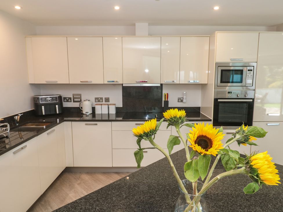 A kitchen with cabinets and appliances at Peninsula Apartment 2 in St Ives