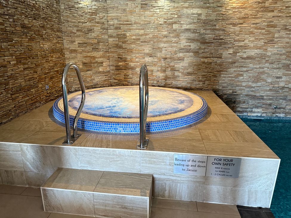 A jacuzzi with steps in a room at Peninsula Apartment 2 St Ives
