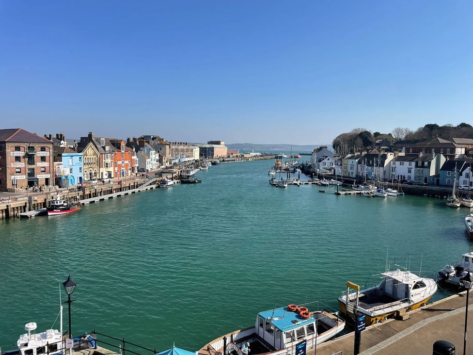 A view of the harbor with boats and buildings at Monarch in Brewers Quay Harbour
